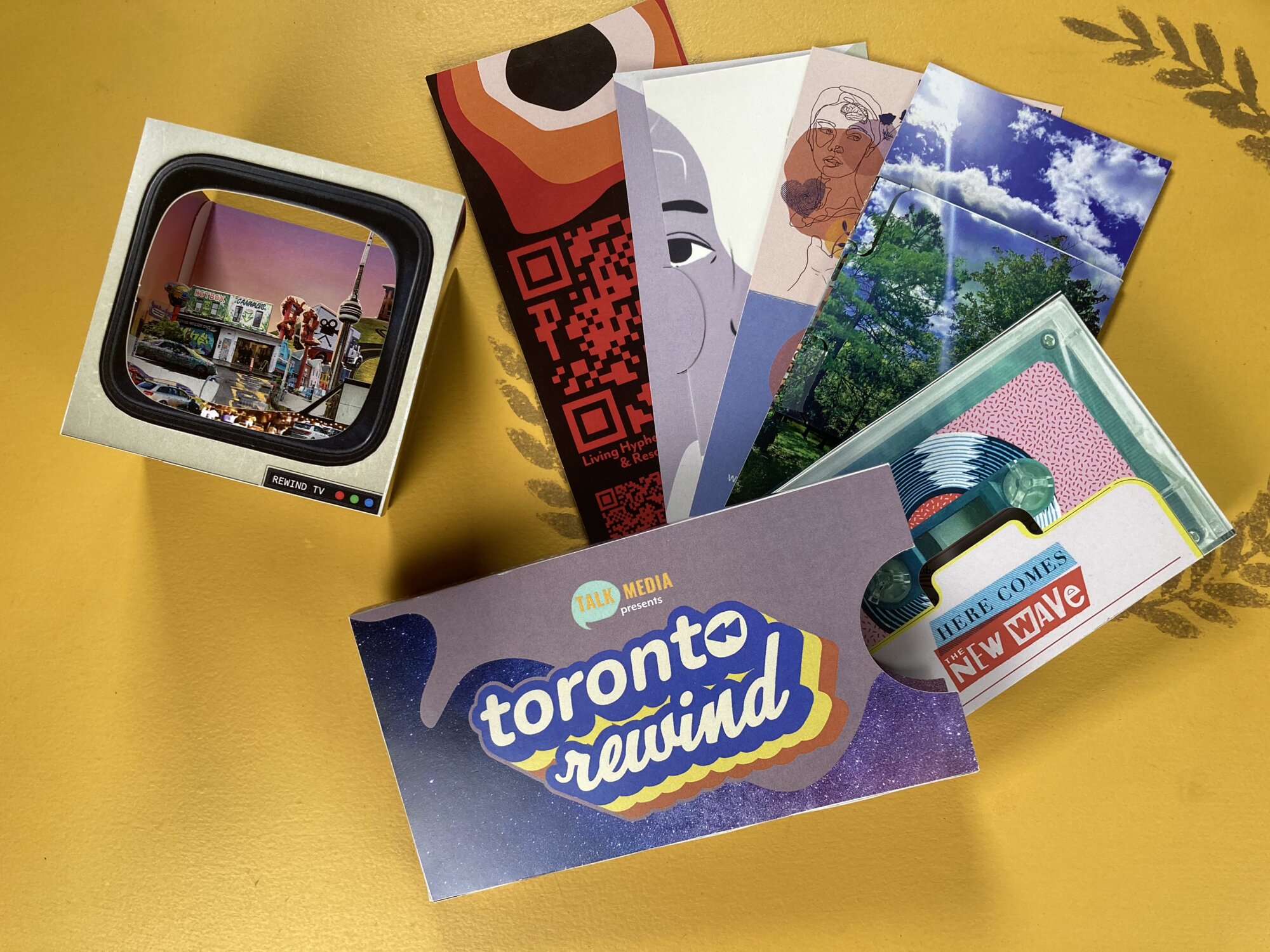 Toronto Rewind mailed storytelling package with illustrated cards, a viewer box and event postcard on a yellow surface